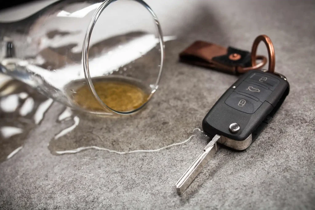 Car keys next to a spilled drink owned by a drunk driver